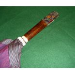 A Chinese silk umbrella with carved horn handle