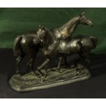 A bronzed figure group of two horses , 25cm tall and 29cm wide