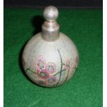 An opaque glass scent bottle with flower decoration and silver lid