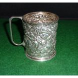 An embossed silver mug