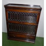 A Wernicke bookcase in oak with leaded glass doors and drawer to base 2 ft 10 inch wide.3 ft 4