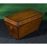 An inlaid mahogany tea caddy on four bun feet