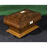 A mahogany tea caddy with ivory cartouche and escutcheon