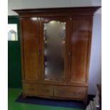 An Edwardian inlaid mahogany triple door wardrobe