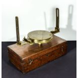 A brass compass in wooden case