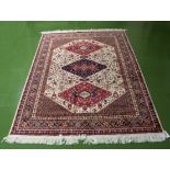 A beige ground Caucasion rug, 1.9m x 1.4m