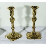 A pair of Queen Anne brass candlesticks