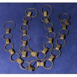 A pair of brass curtain ties