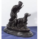 A bronze game keeper with his dog