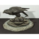 A bird of prey with it's catch on stone base