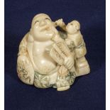 An ivory netsuke, Buddha with boy