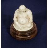 A carved ivory on wooden base