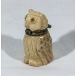 A carved ivory lidded box modelled as an owl