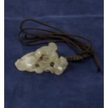 A Chinese carved jade pendant of a dog and puppy