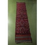 A hand knotted woolen red ground runner, 58cm x 260