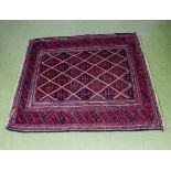 A hand knotted red ground woolen rug 117cm x 130