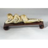 A carved ivory medical figure on hardwood base