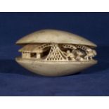 A carved ivory clam shell, signed