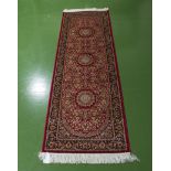 A red ground Keshan runner, 2.1m x 0.7m