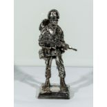 A cold cast silvered figure of a soldier