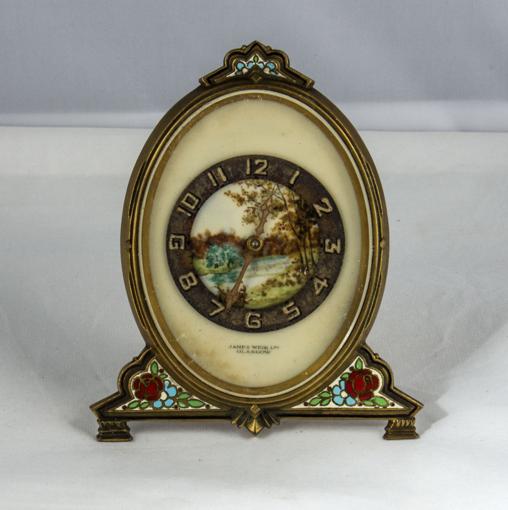 An enamelled brass desk time piece James Weir Ltd Glasgow