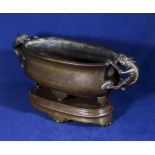 A bronze censer with demon handles on stand