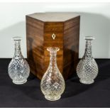 Three glass decanters in fitted mahogany box