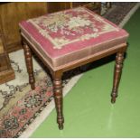 A Victorian stool with tapestry seat