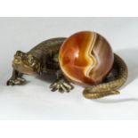 A bronze lizard with agate ball