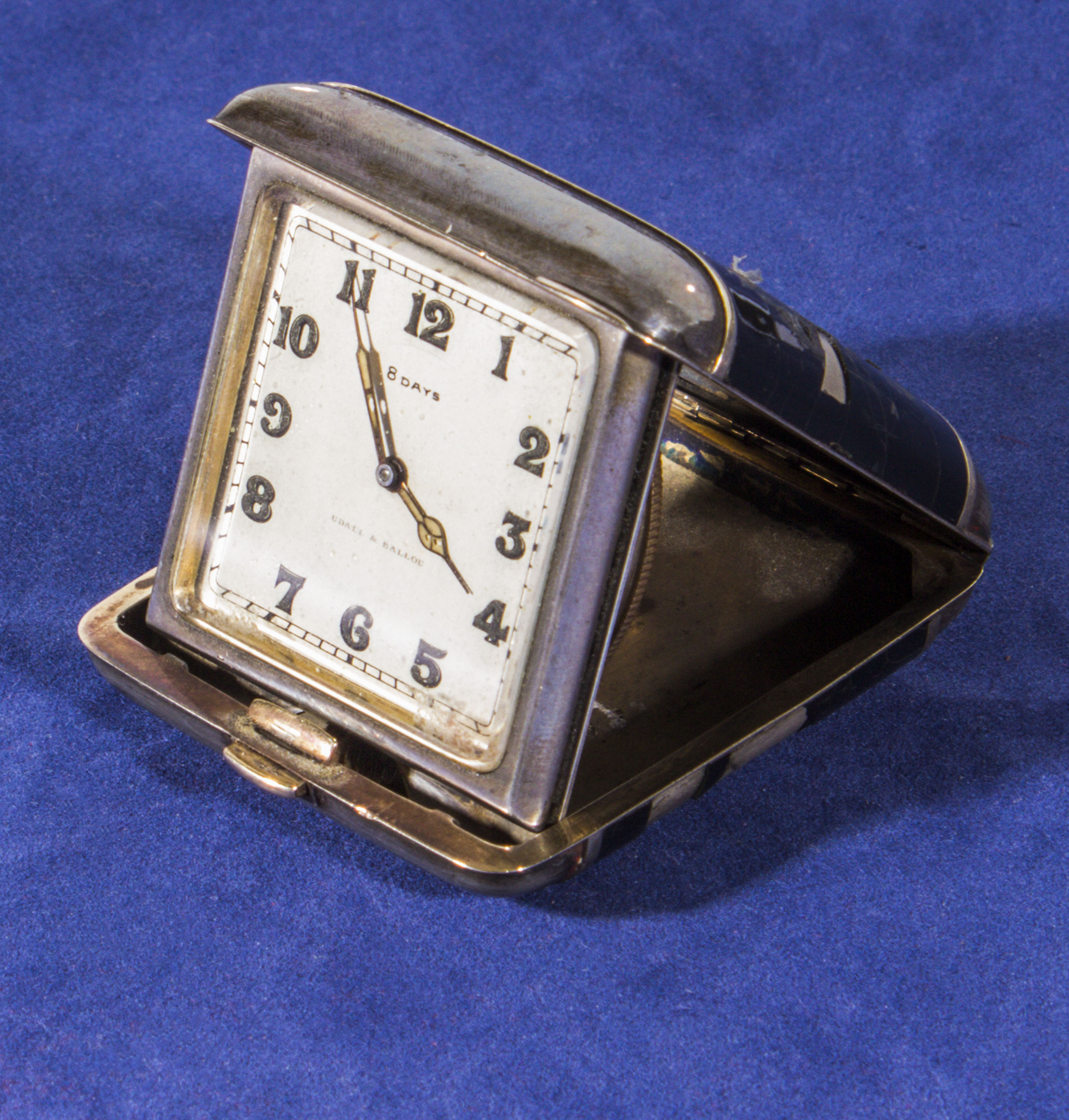 A silver and enamel travel clock