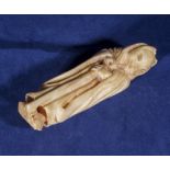 An ivory netsuke modelled as a wolf