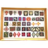 40 cloth formation signs. A good selection, including WW2, Korea and other post war examples. Framed