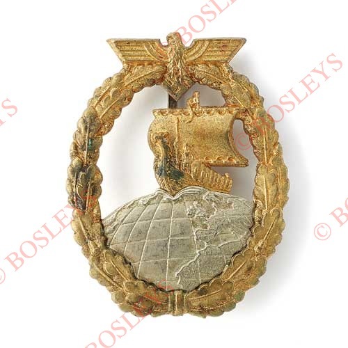 German Third Reich WW2 Kriegsmarine Auxiliary Cruiser Badge. A fine die-cast example. Gilt oval