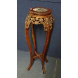 An oriental rose wood vase stand having a marble inset top over a carved base