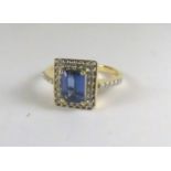 An 18ct gold and tanzanite plaque ring set with brilliant cut diamonds and diamond set shoulders