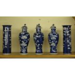 Circa 1922, two blue and white Chinese cylindrical vases, together with three matching vases with