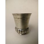 A 19th century continental silver beaker with gadrooned base, marks verso, 3" high