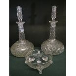 A pair of late Victorian/Edwardian cushioned globe and shaft decanters with cut bodies, faceted