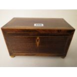 An early 19th century inlaid mahogany two-section tea caddy standing on gilt ball feet