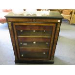 A Victorian walnut and ebonized dwarf bookcase with inlaid medallion and ormolu mounts, glazed