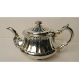 An early 19th century Georgian silver teapot with ornate handle, rose head knop, London 1823
