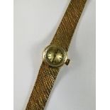A 9ct gold cased Omega ladies wrist watch with silvered dial marked Omega, having gold coloured