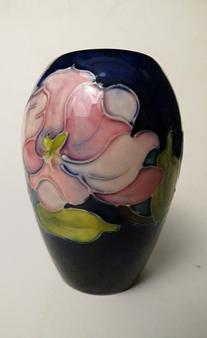 Walter Moorcroft Magnolia pattern vase of ovoid form, decorated on a blue ground