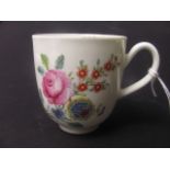 An 18th century Worcester porcelain coffee cup with polychrome floral decoration and a fluted handle