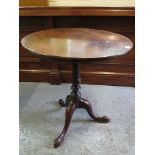 A George III mahogany snap top, bird cage table over a turned column and splayed legs