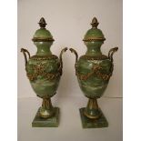 A pair of green onyx and gilt brass garniture urns standing on square bases