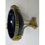 A 20th century cobalt blue porcelain tazza mounted in gilt brass, decorated with rams heads over a