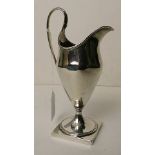 A George III silver cream jug standing on a square base, London 1784, 7" high