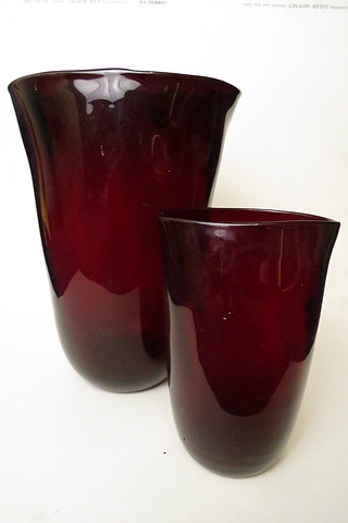 Two European ruby glass tumbler vases of misshapen form, the tallest 12" high