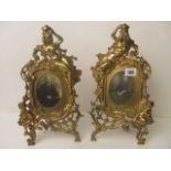 A pair of l ate 19th century ornate brass strut back picture frames